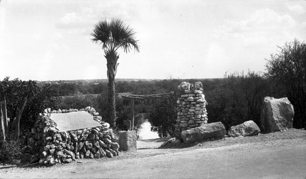 Tori Gate at Alpine Drive entrance, the main access to the garden before St. Mary’s Street was extended into Brackenridge Park.  On left is a plaque with names of the lily pond donors.  Photograph by Al Schaal, circa late 1920s.  (General Photograph Collection MS 362:  109-0252)