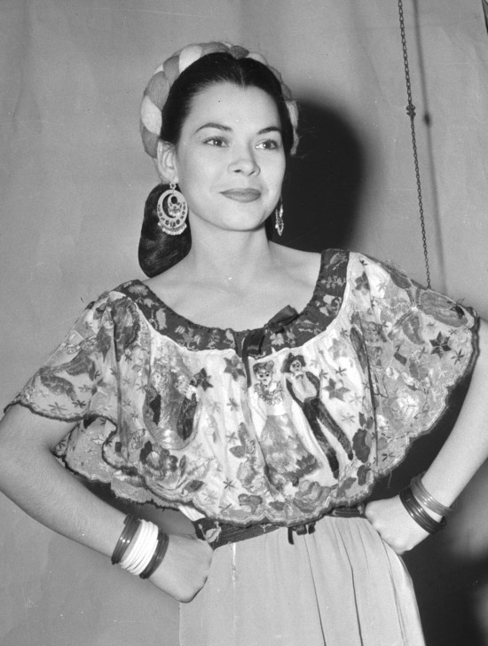 Rosita Fernandez (Almaguer) poses in a Mexican dress shortly before she sang Mexican ballads in a show at La Villita, July 1944.  (MS 359:  L-3132-A).  Fernandez (1919-2006) became a local radio star in the early 1930s, and later appeared on television and in movies.  Lady Bird Johnson gave her the title “San Antonio’s First Lady of Song.”  The Rosita Fernandez Collection is housed in UTSA Special Collections Main Campus:   http://www.lib.utexas.edu/taro/utsa/00043/utsa-00043.html  