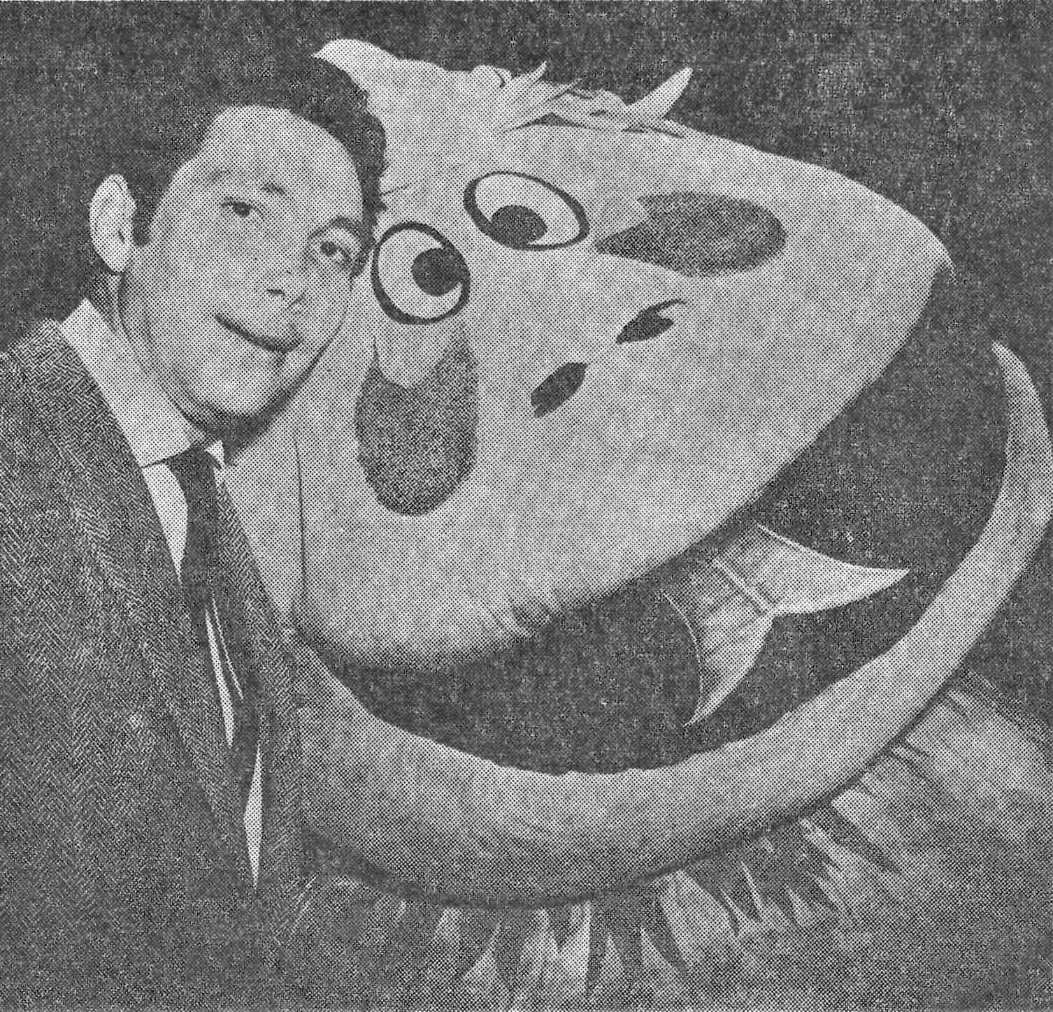 Black and white photograph of puppeteer Mart Krofft with the "beast" mascot puppet from the Krofft brothers' "Kaleidoscope" show at Hemisfair '68 in San Antonio, Texas.